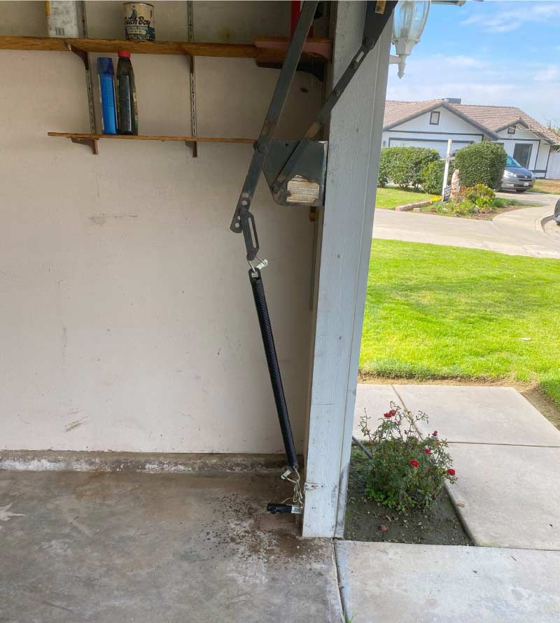 Close-up of a misaligned garage door of a homeowner in visalia, ca, before calling for emergency garage repair